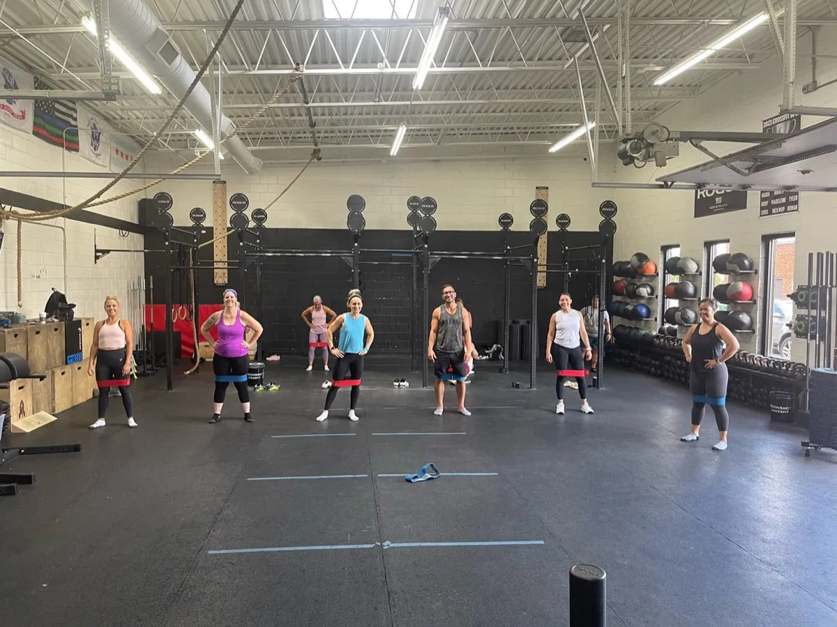 Members warming up with resistance bands during a CrossFit class at Moonshot