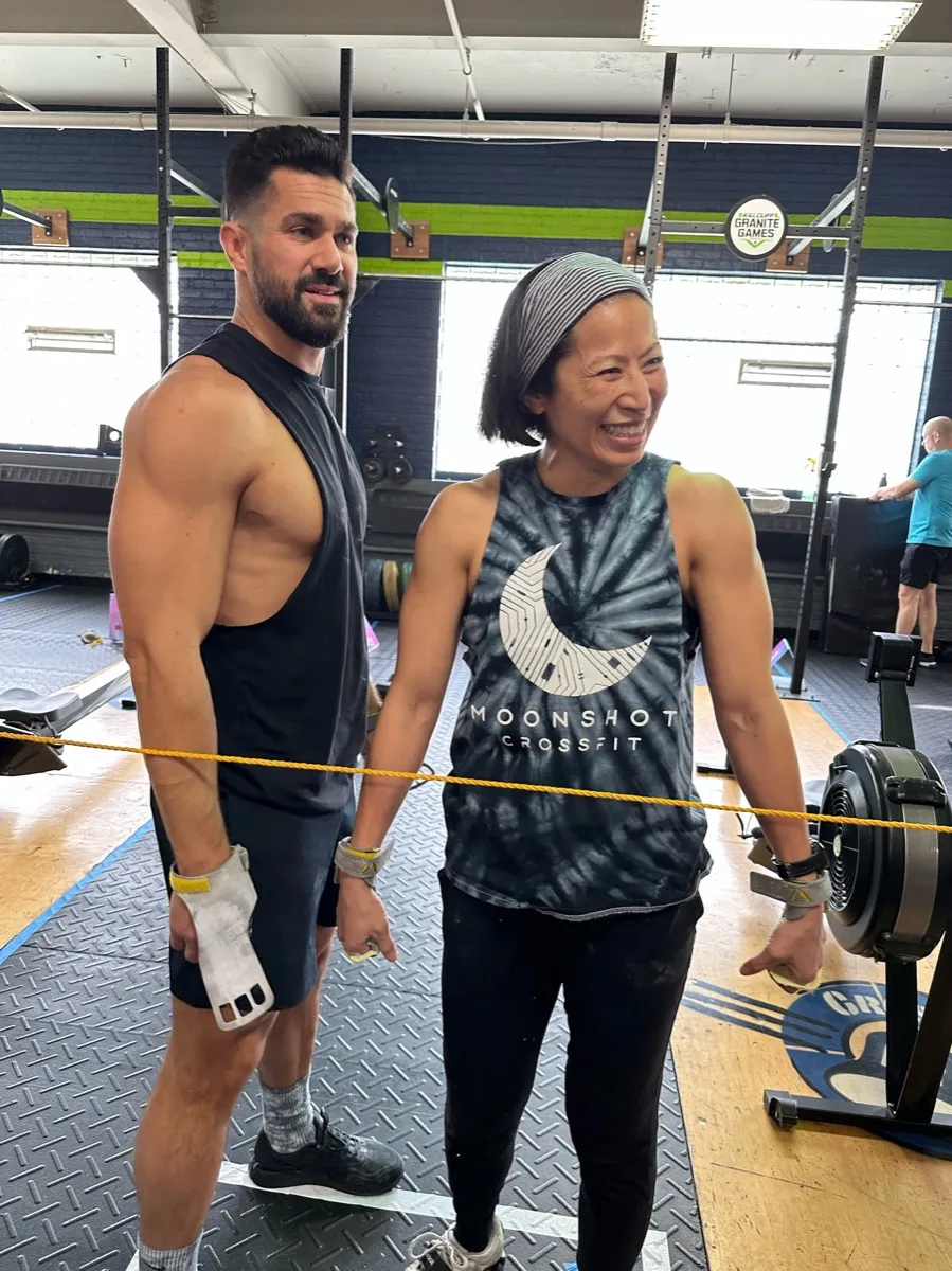 A Moonshot CrossFit coach and member laughing together during a session