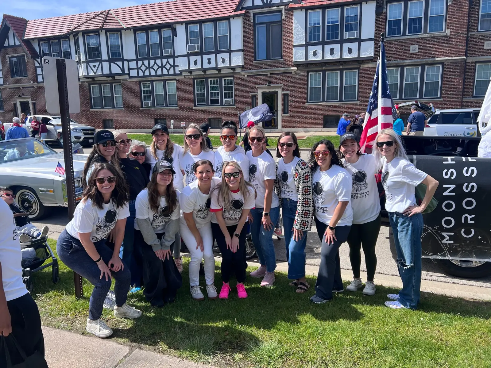Moonshot CrossFit members wearing matching shirts and posing together at a local community parade