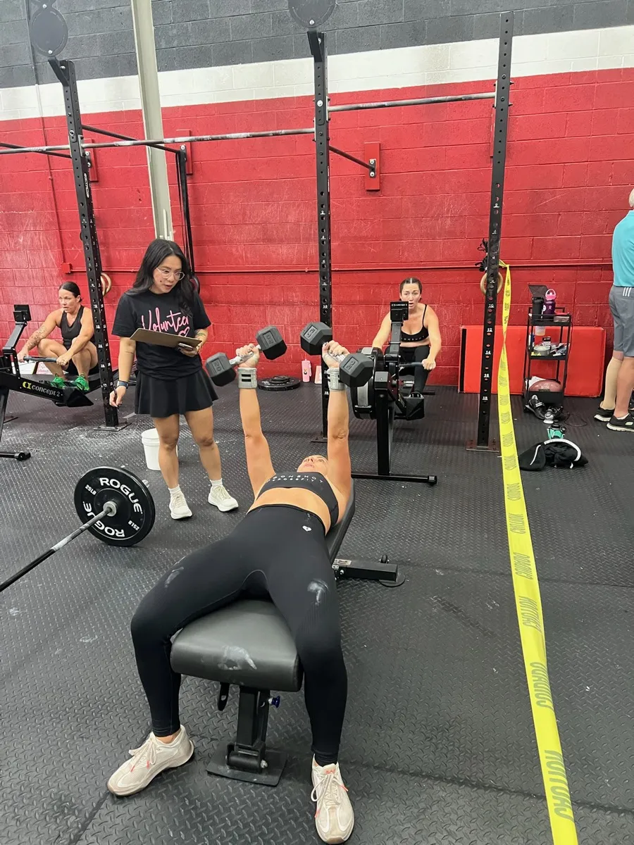 A member performing a dumbbell workout at Moonshot CrossFit