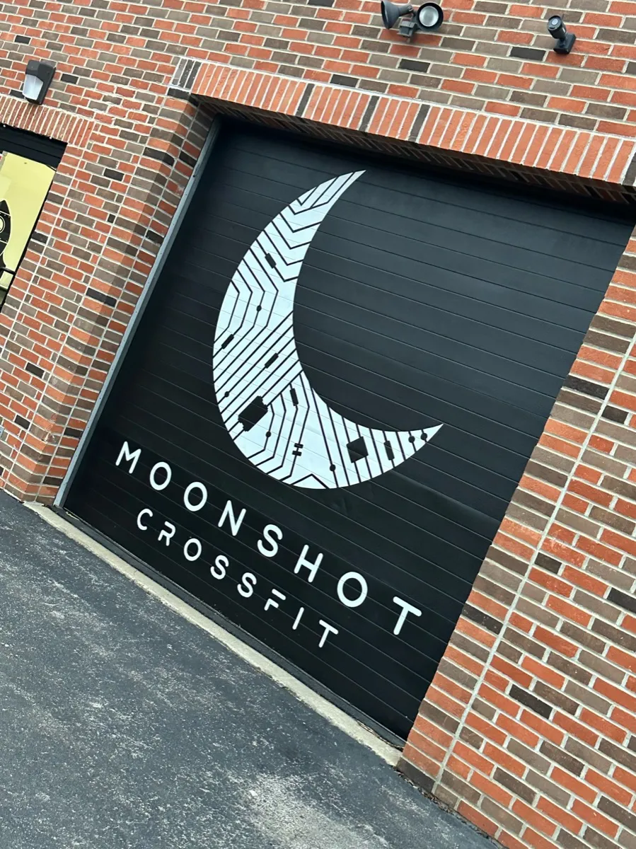 Moonshot CrossFit exterior showing the iconic moon logo on the garage door in Park Ridge