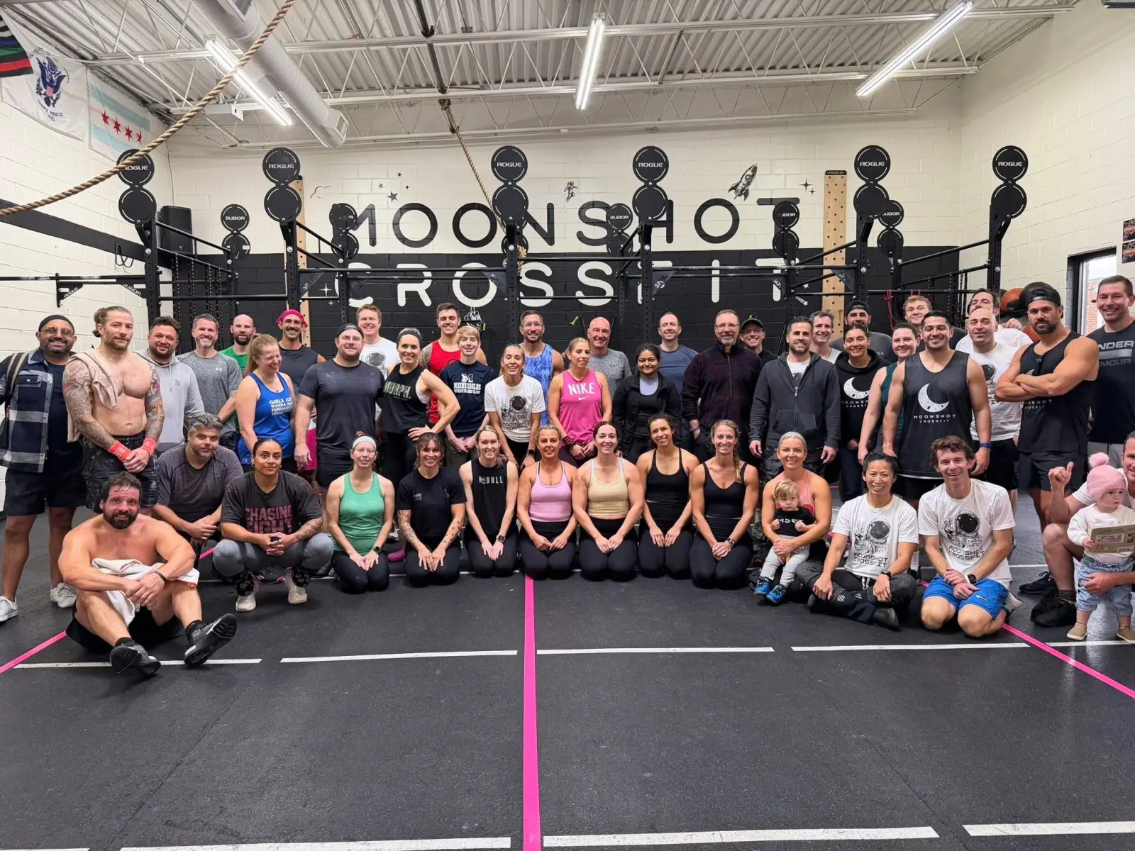 A large group of Moonshot CrossFit members posing together on the gym floor after a workout
