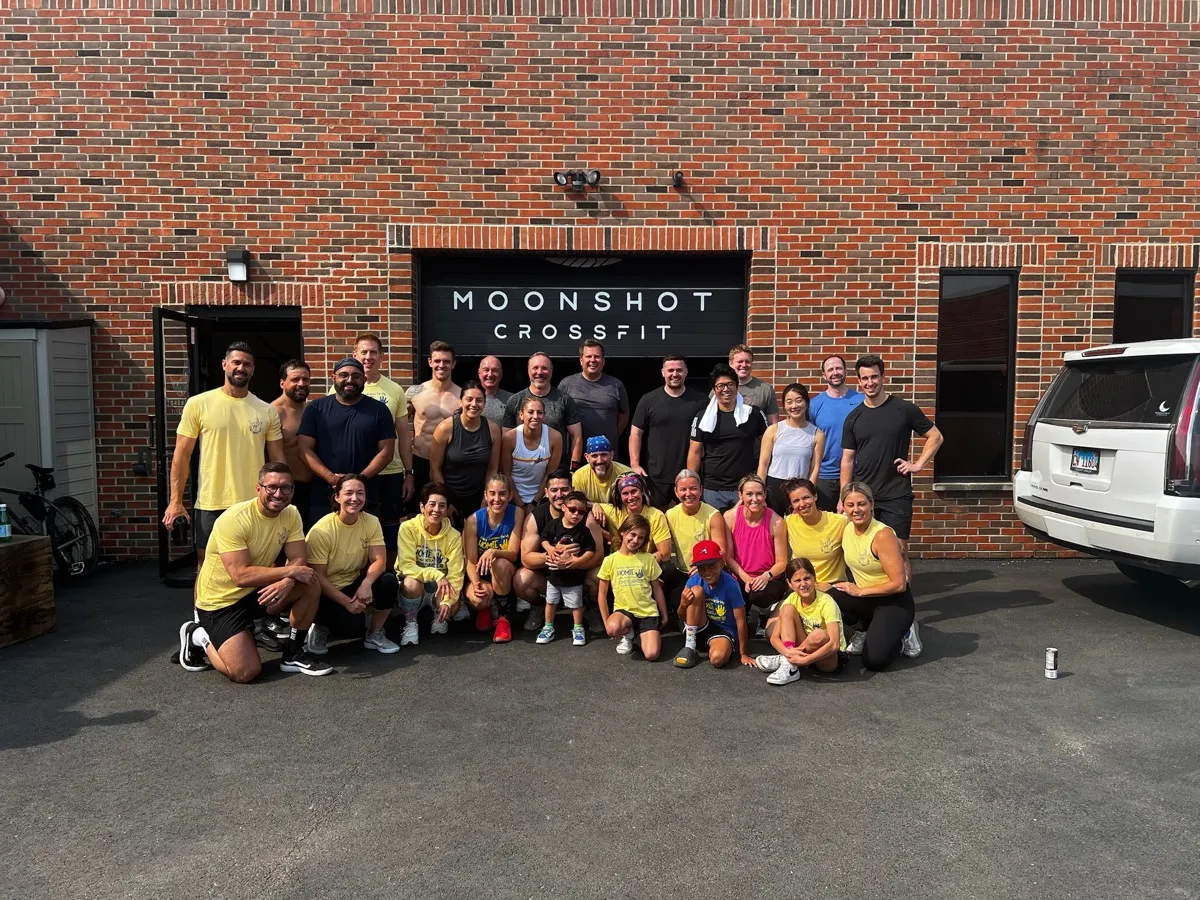 Moonshot CrossFit members in matching shirts gathered outside the gym