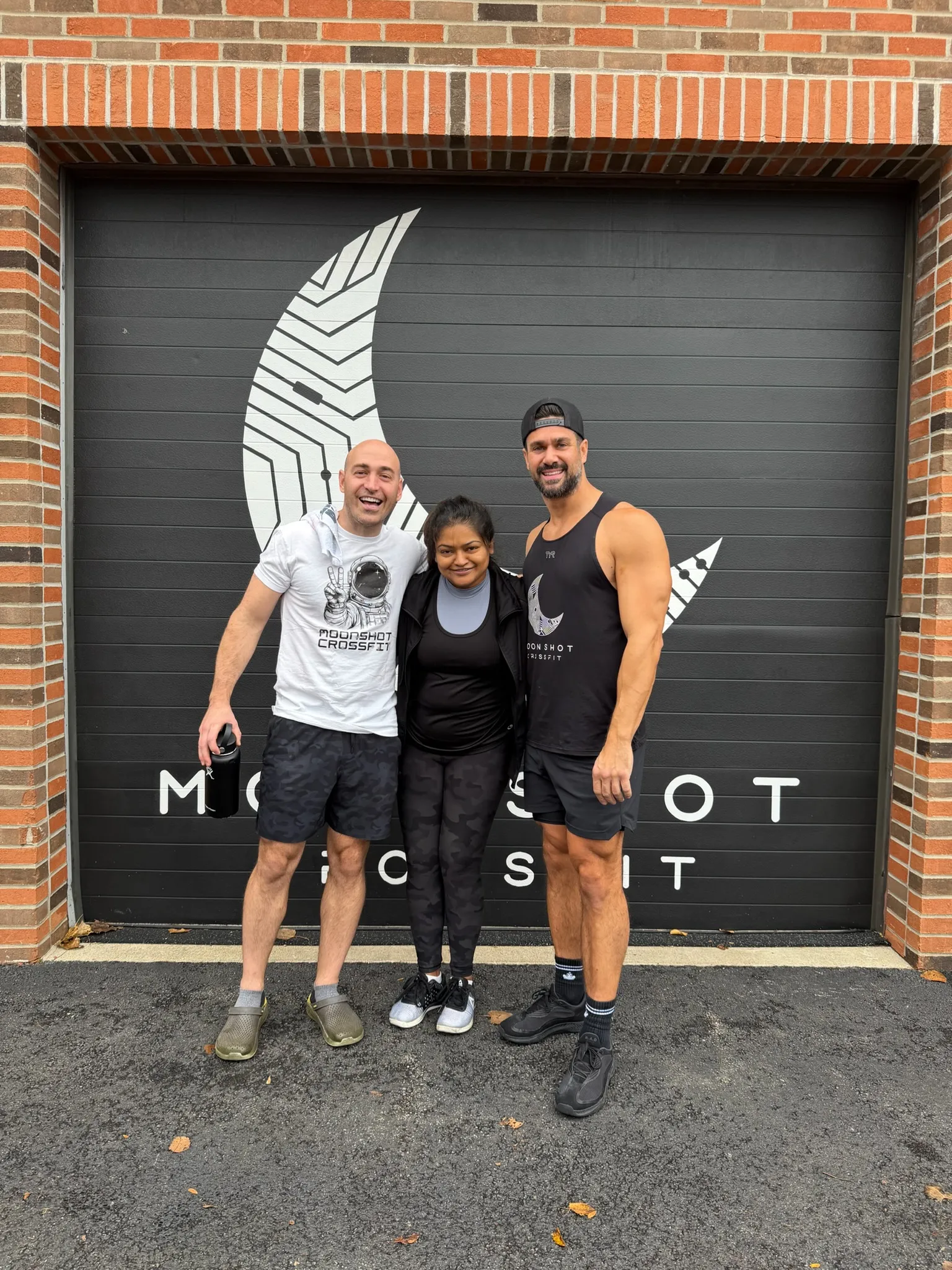 Moonshot CrossFit members and coaches posing outside the gym in Park Ridge