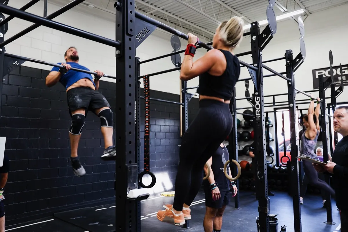 Members doing pull-ups during a coached CrossFit workout at Moonshot CrossFit