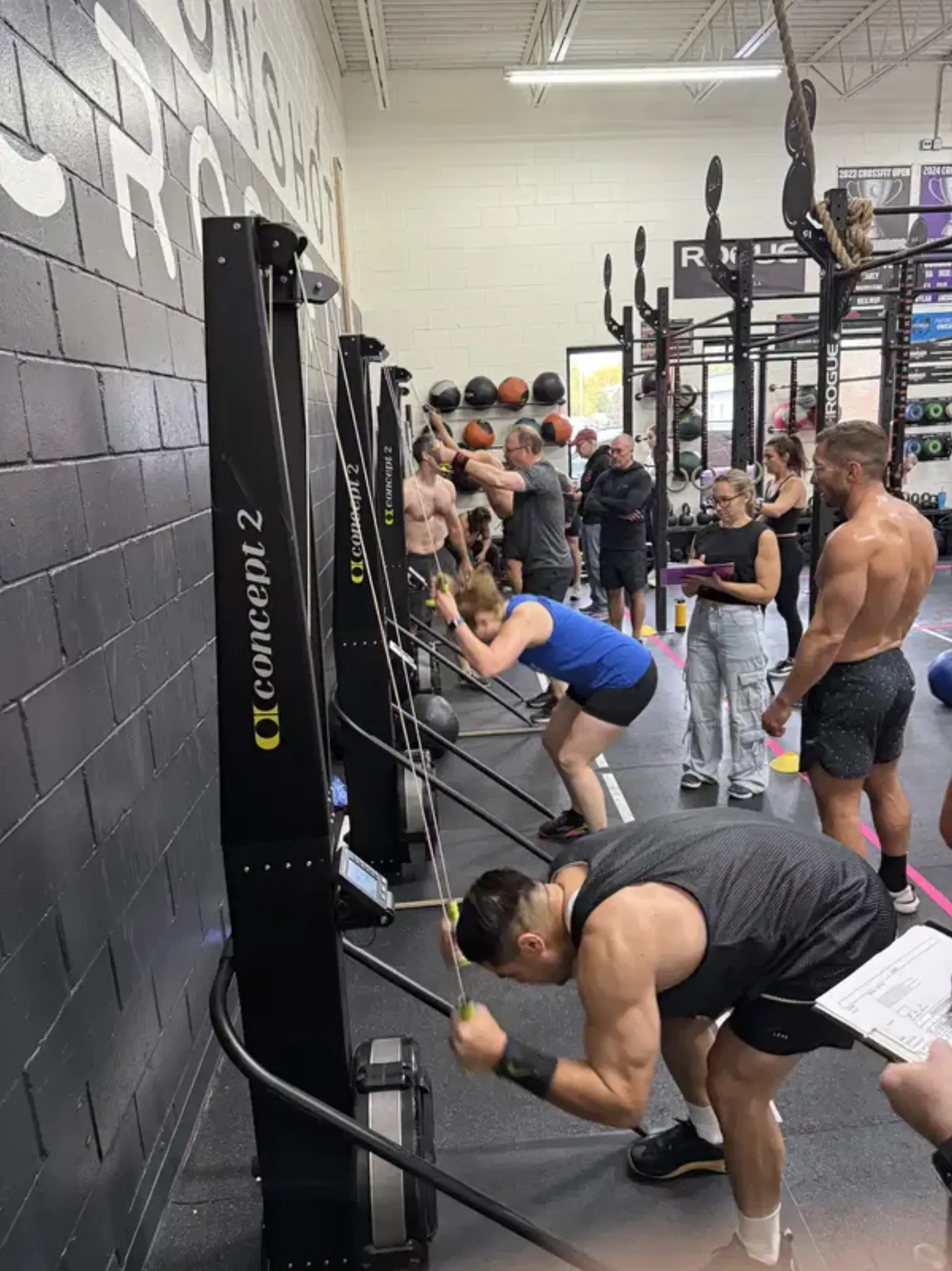 Members working out on Concept 2 ski ergs during a training session at Moonshot CrossFit