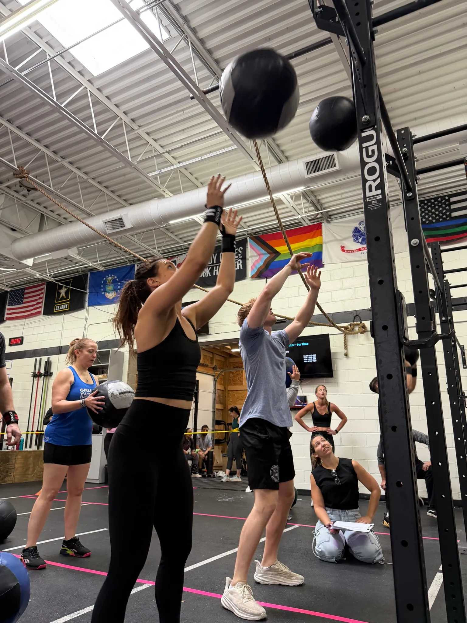Members throwing wall balls during a workout at Moonshot CrossFit