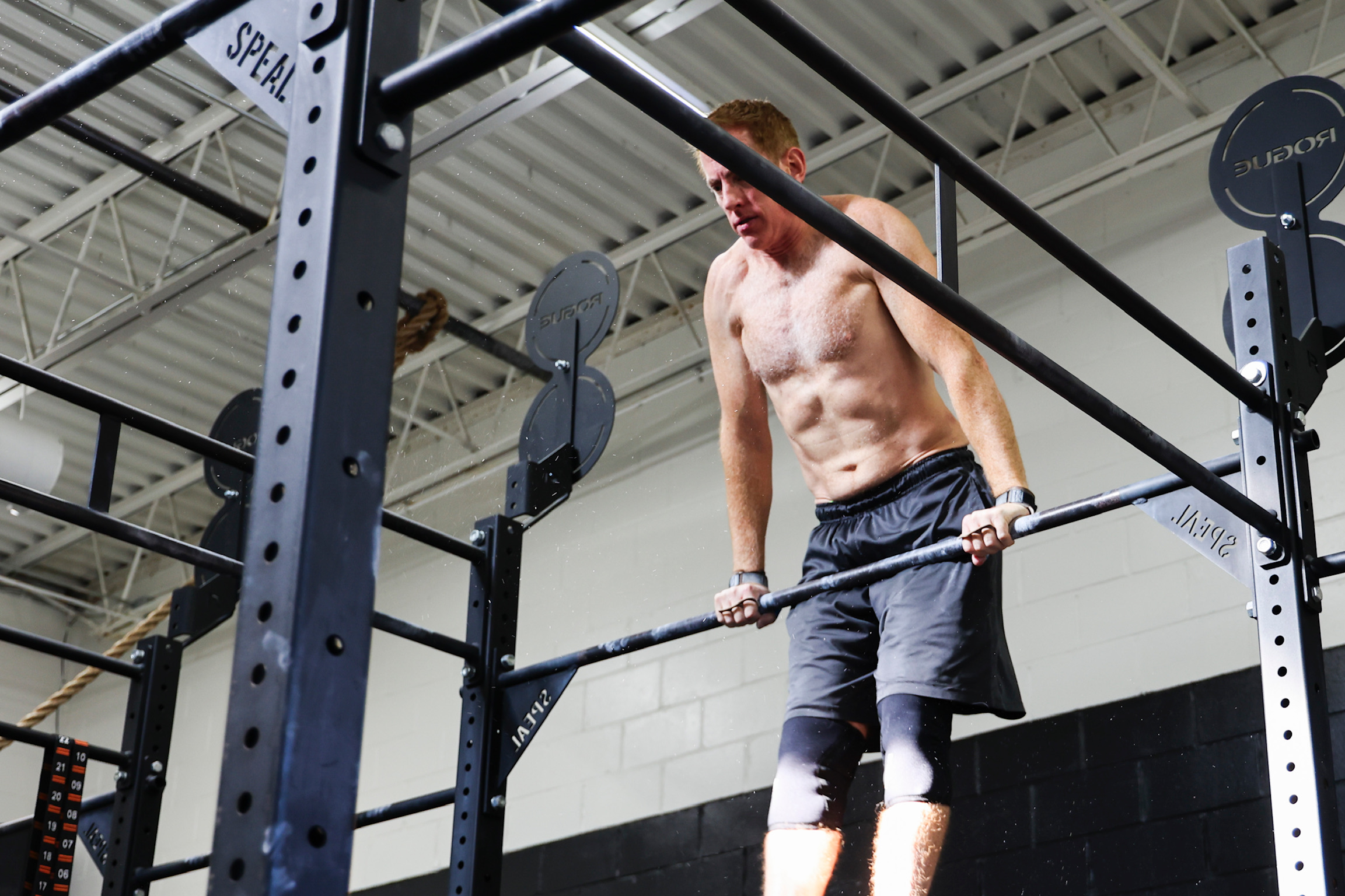 Coach demonstrating a muscle-up