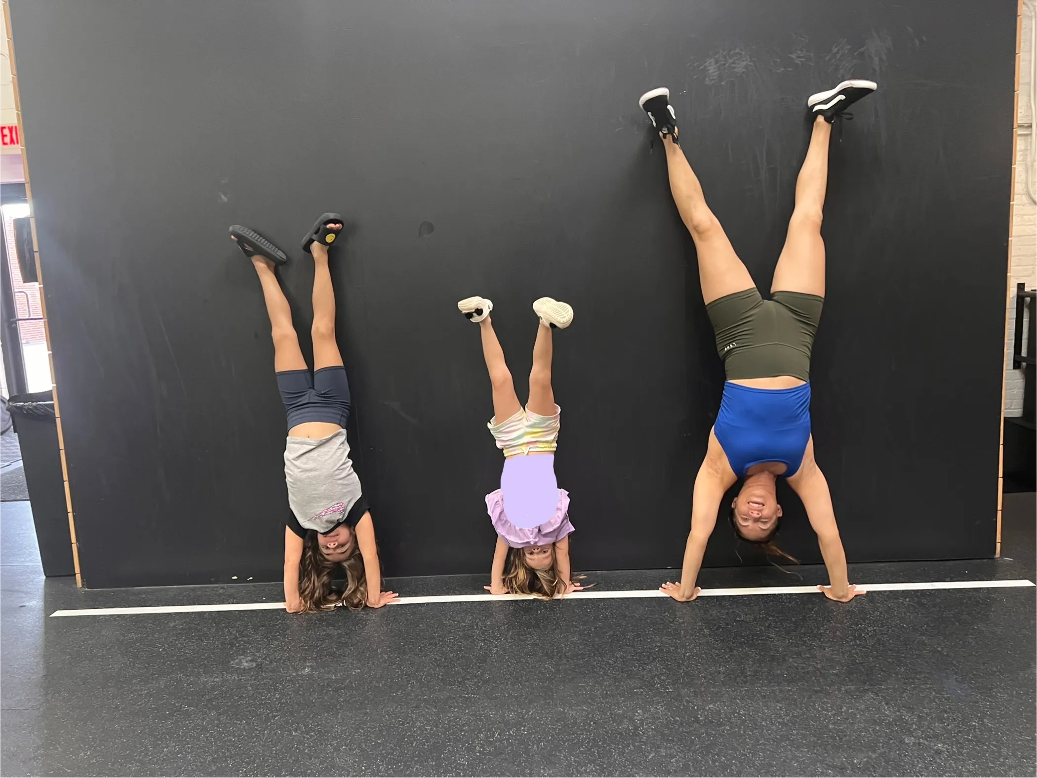 Coach Sarah teaching a youth handstand class